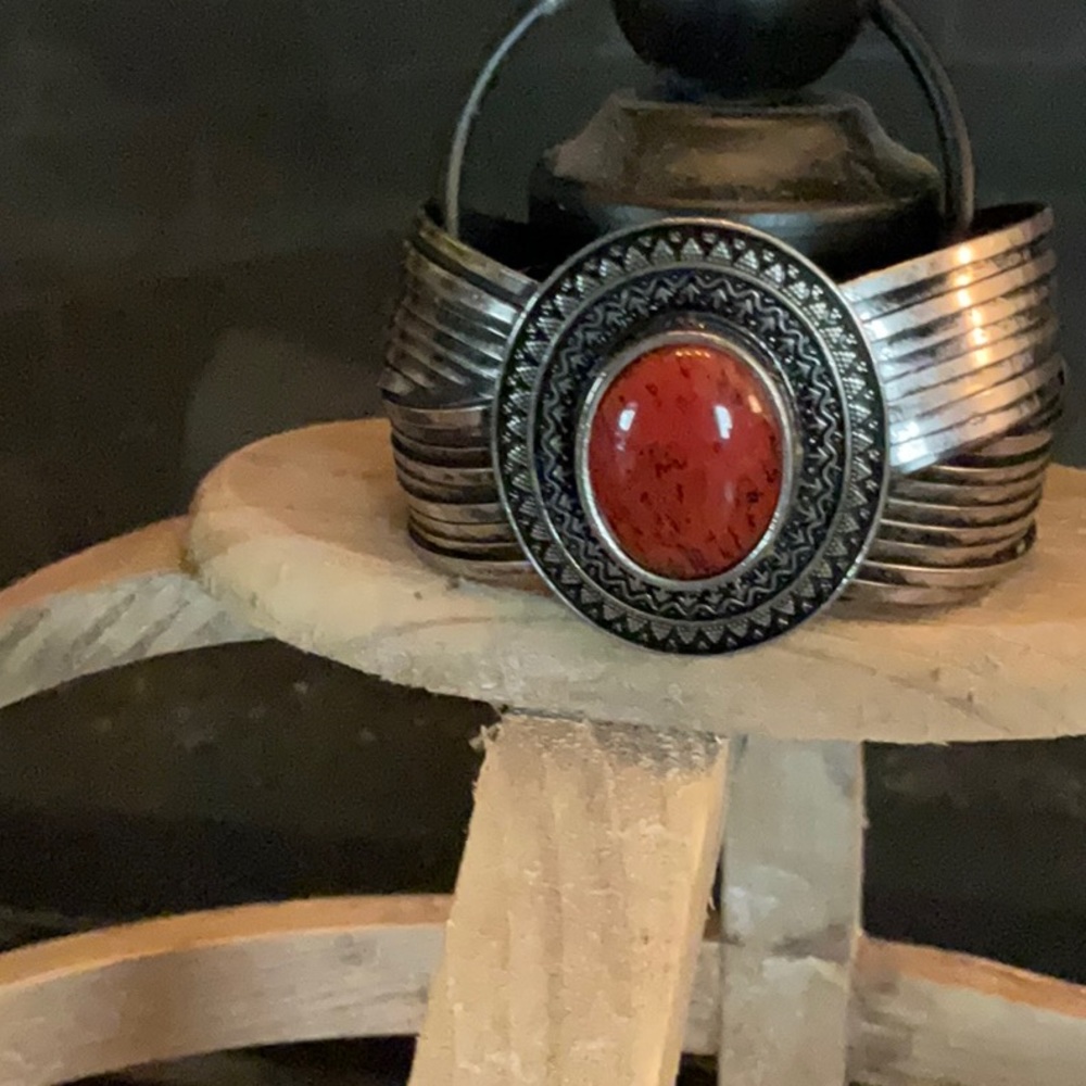 Beautiful cuff bracelet in burnished, silver and simulated red coral stone